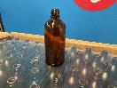 Thumbnail '4' of 140x Approx Amber Coloured Glass-Like 100mL Bottles